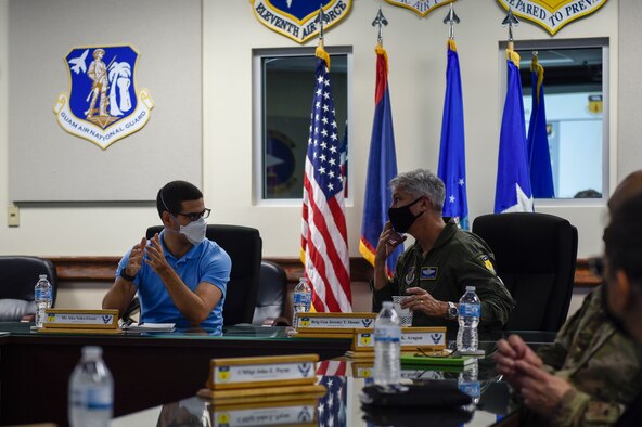 A group of people sitting on a bus and talking.