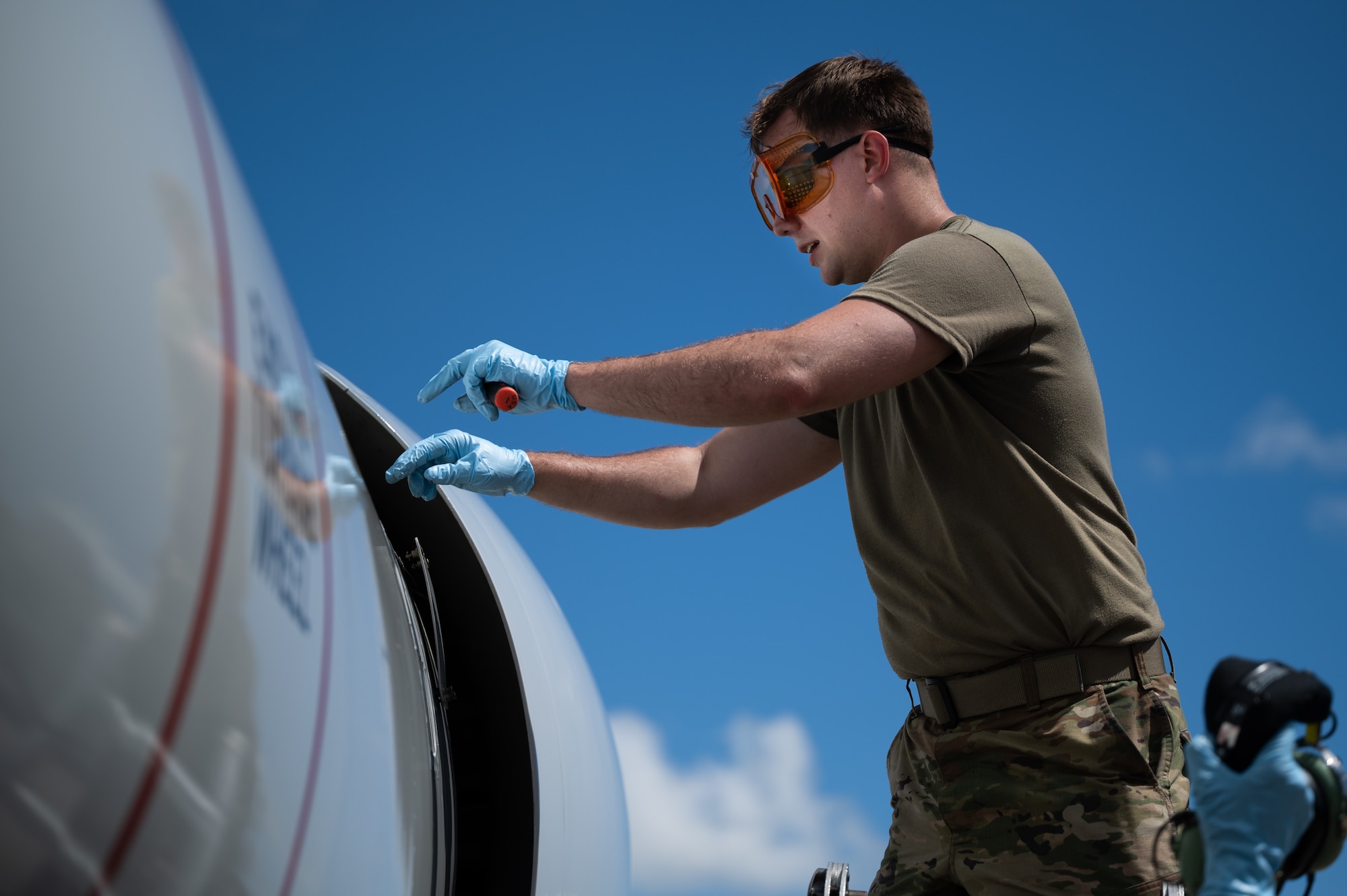 U.S. Air Force Airman 1st Class Andrew Foust, 961st Aircraft Maintenance Unit aerospace propulsion apprentice, inspects an E-3 Sentry engine at Kadena Air Base, Japan, Aug. 30, 2021. E-3 Sentries are capable of command, control and communications operations for tactical and air defense forces. (U.S. Air Force photo by Airman 1st Class Stephen Pulter)