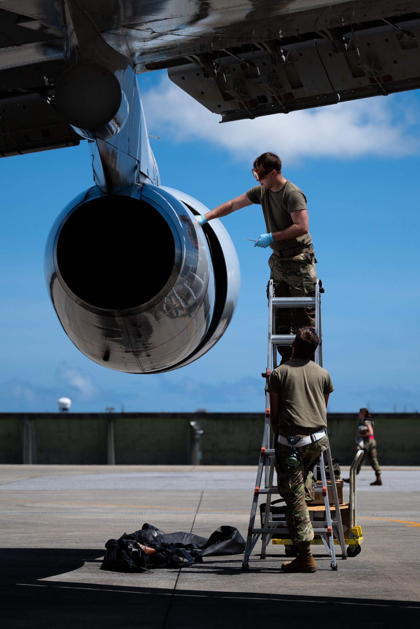 U.S. Air Force Airman 1st Class Andrew Foust, top, 961st Aircraft Maintenance Unit aerospace propulsion apprentice, and Airman 1st Class Trevor Fisher, bottom, 961st AMU aerospace propulsion apprentice, inspect an E-3 Sentry engine at Kadena Air Base, Japan, Aug. 30, 2021. The 961st AMU is under the 18th Aircraft Maintenance squadron, one of five squadrons under the 18th Maintenance Group. (U.S. Air Force photo by Airman 1st Class Stephen Pulter)