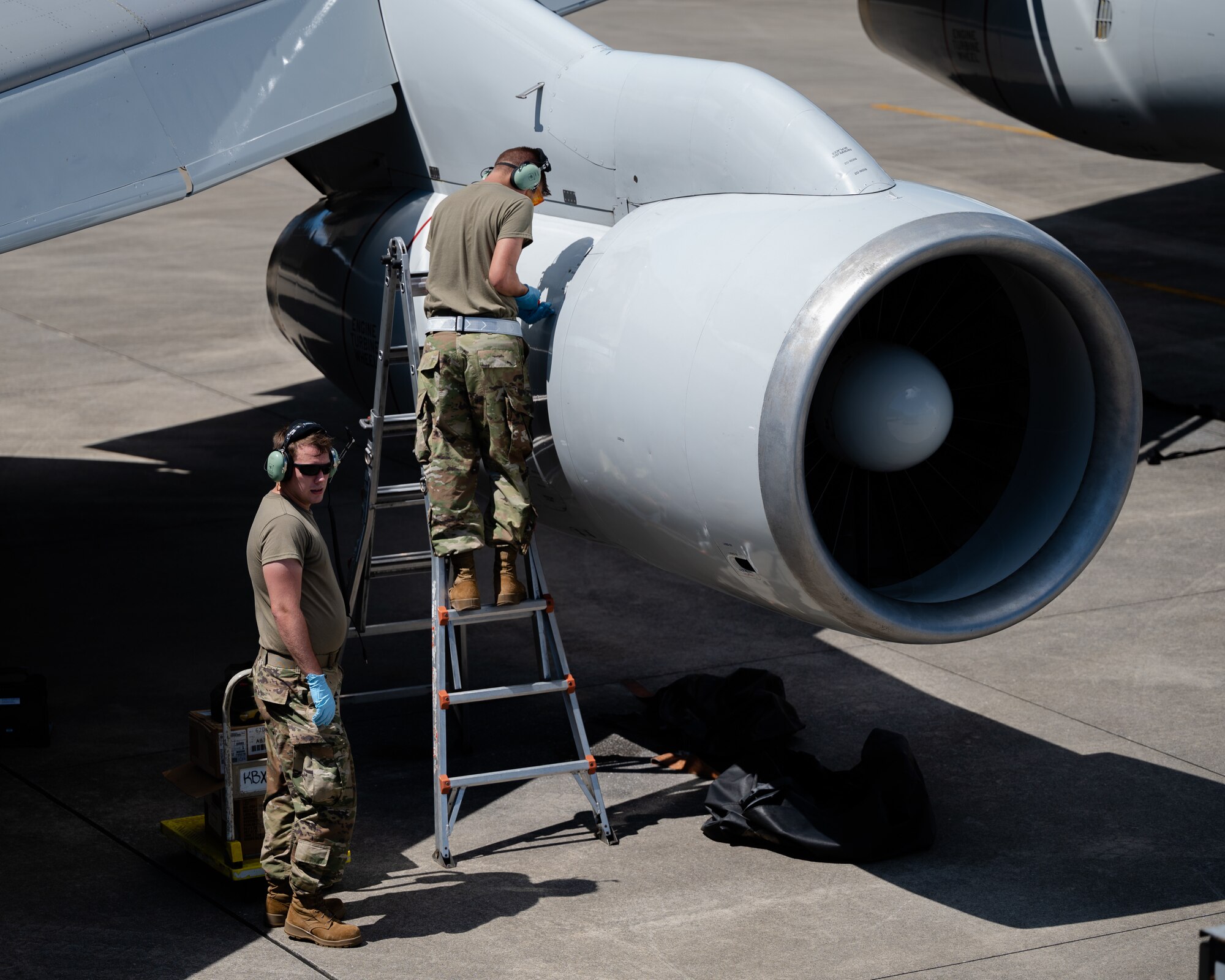 U.S. Air Force Airman 1st Class Andrew Foust, left, 961st Aircraft Maintenance Unit aerospace propulsion apprentice, and Airman 1st Class Trevor Fisher, right, 961st AMU aerospace propulsion apprentice, inspect an E-3 Sentry engine at Kadena Air Base, Japan, Aug. 30, 2021. The 961st AMU are responsible for ensuring E-3 Sentries are capable of protecting U.S. and coalition force interests in the INDO-Pacific region. (U.S. Air Force photo by Airman 1st Class Stephen Pulter)