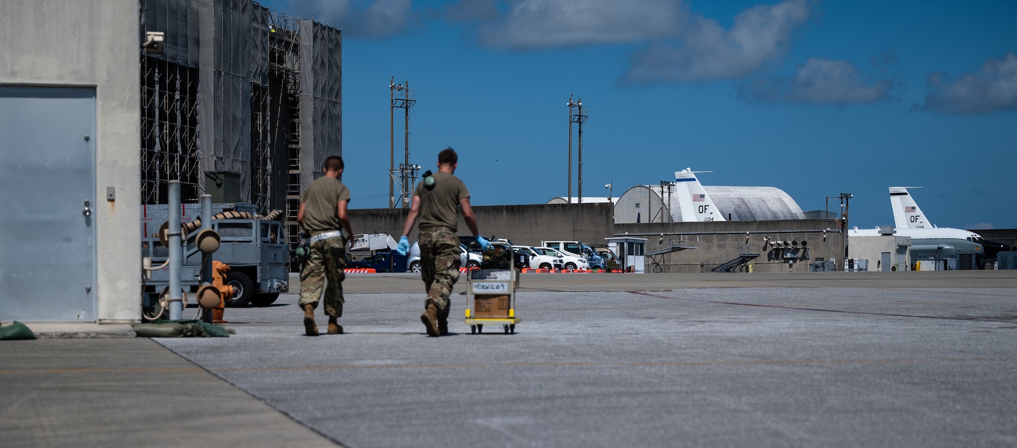 U.S. Air Force Airman 1st Class Trevor Fisher, left, 961st Aircraft Maintenance Unit aerospace propulsion apprentice, and Airman 1st Class Andrew Foust, right, 961st AMU aerospace propulsion apprentice, walk back to the 961st AMU at Kadena Air Base, Japan, Aug. 30, 2021. The 961st AMU works around the clock to ensure E-3 Sentries remain mission ready to defend and support the U.S. and coalition partners. (U.S. Air Force photo by Airman 1st Class Stephen Pulter)