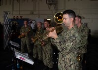 Musician 3rd Class Alessandro Bonotto plays trumpet during a key leadership engagement aboard the Expeditionary Sea Base USS Hershel "Woody" Williams (ESB 4), Sept. 1, 2021. Hershel "Woody" Williams is on a scheduled deployment in the U.S. Sixth Fleet area of operations in support of U.S. national interests and security in Europe and Africa.