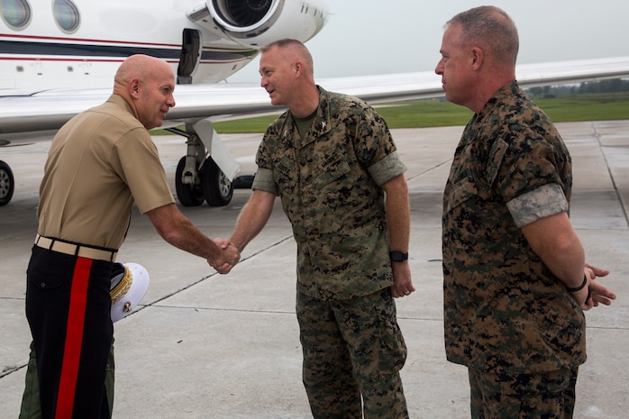 U.S. Marine Corps Gen. David H. Berger, left, the commandant of the Marine Corps, is greeted by Col. Curtis V. Ebitz, center, the commanding officer of Marine Corps Air Station New River, and Sgt. Maj. Douglas W. Gerhardt, right, the MCAS New River sergeant major, after arriving on MCAS New River, North Carolina, Aug. 26, 2021.