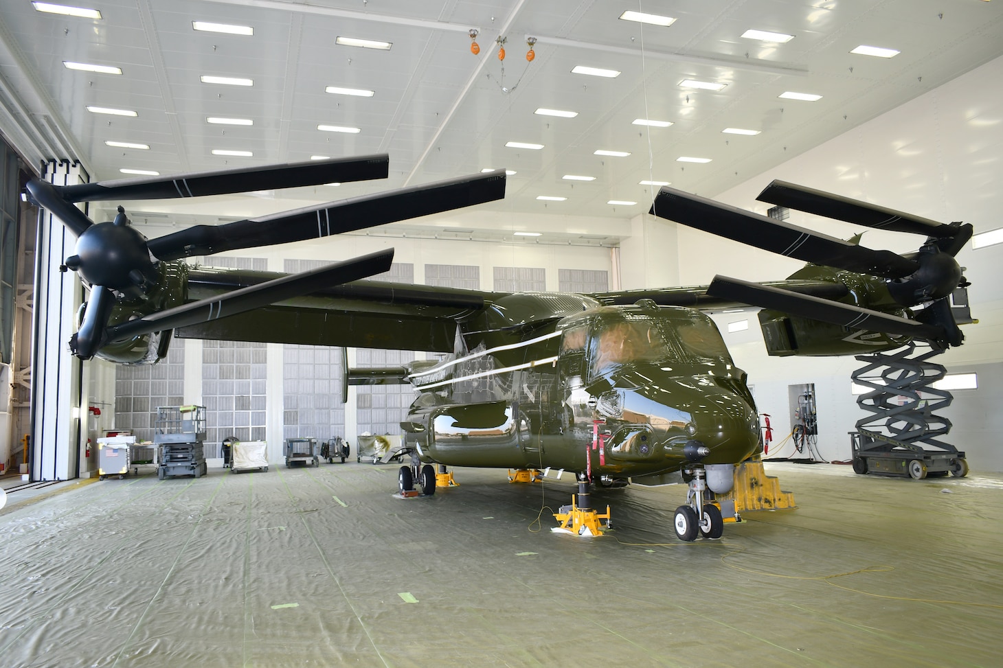 A newly painted aircraft sits in a hangar