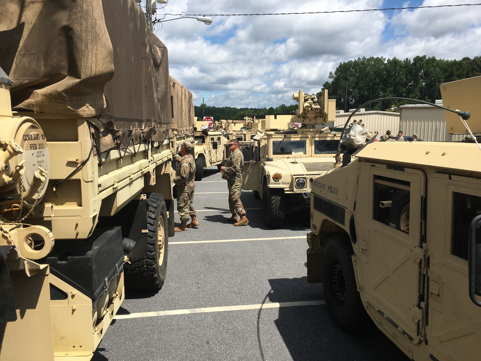 A massive convoy of Georgia National Guard personnel and equipment prepares to depart the armory of the 170th Military Police Battalion, 201st Regional Support Group, in Decatur, Georgia, Sept. 1, 2021. Convoys from across the state are moving relief supplies and heavy equipment along with Citizen-Soldiers and -Airmen who have honed their expertise at debris removal, transportation and logistics support, security and traffic control during responses to Hurricanes Irma, Michael and Dorian.