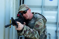 Tech. Sgt. Ryan Brier, 158th Fighter Wing chapel operations NCO in charge, prepares to clear a building during the Deployed Security Operations Chaplains Course, Aug. 26, 2021, at the Camp Ethan Allen Training Site, Jericho, Vermont. The three-day training course was developed by 158th religious affairs and security forces Airmen as a crash course in weapons handling and familiarization, general security procedures, convoy operations and improvised explosive device recognition. (U.S. Air National Guard photo by Tech. Sgt. Shane Phipps)