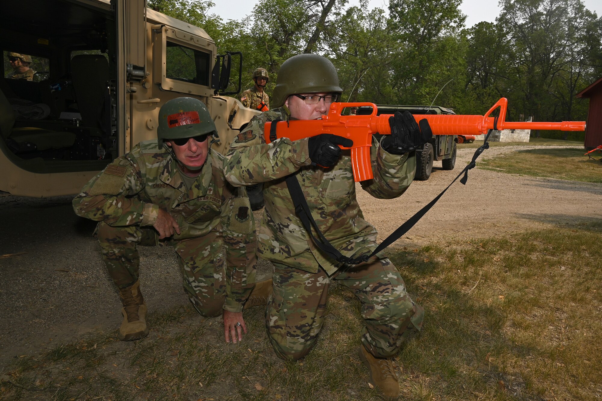 An enlisted religious affairs specialist practices defending his chaplain during a simulated enemy attack while conducting military training at Camp Grafton Training Center, N.D., Aug. 3, 2021.