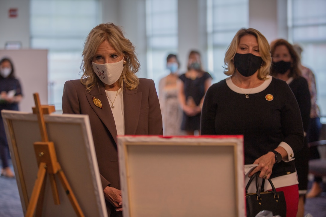 Dr. Jill Biden, first lady of the United States, and Stacie Black, spouse of the Sergeant Major of the Marine Corps, look at artwork created by a veteran during a visit to the Midway Park Behavioral Health Complex on Camp Lejeune, North Carolina, Sept. 1, 2021.