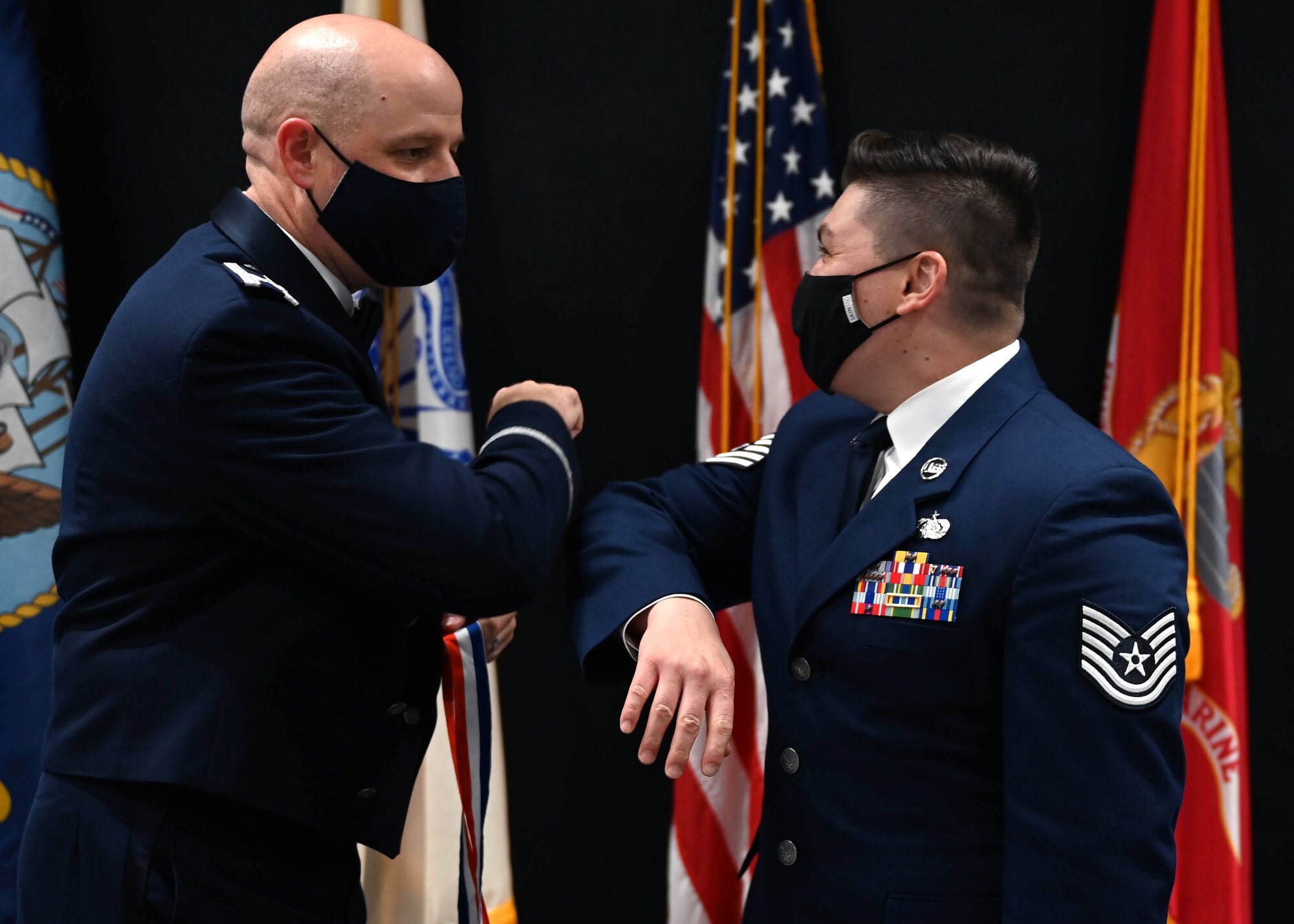 Col. Matthew Reilman elbow bumps an inductee during the Senior Noncommissioned Officer Induction Ceremony.