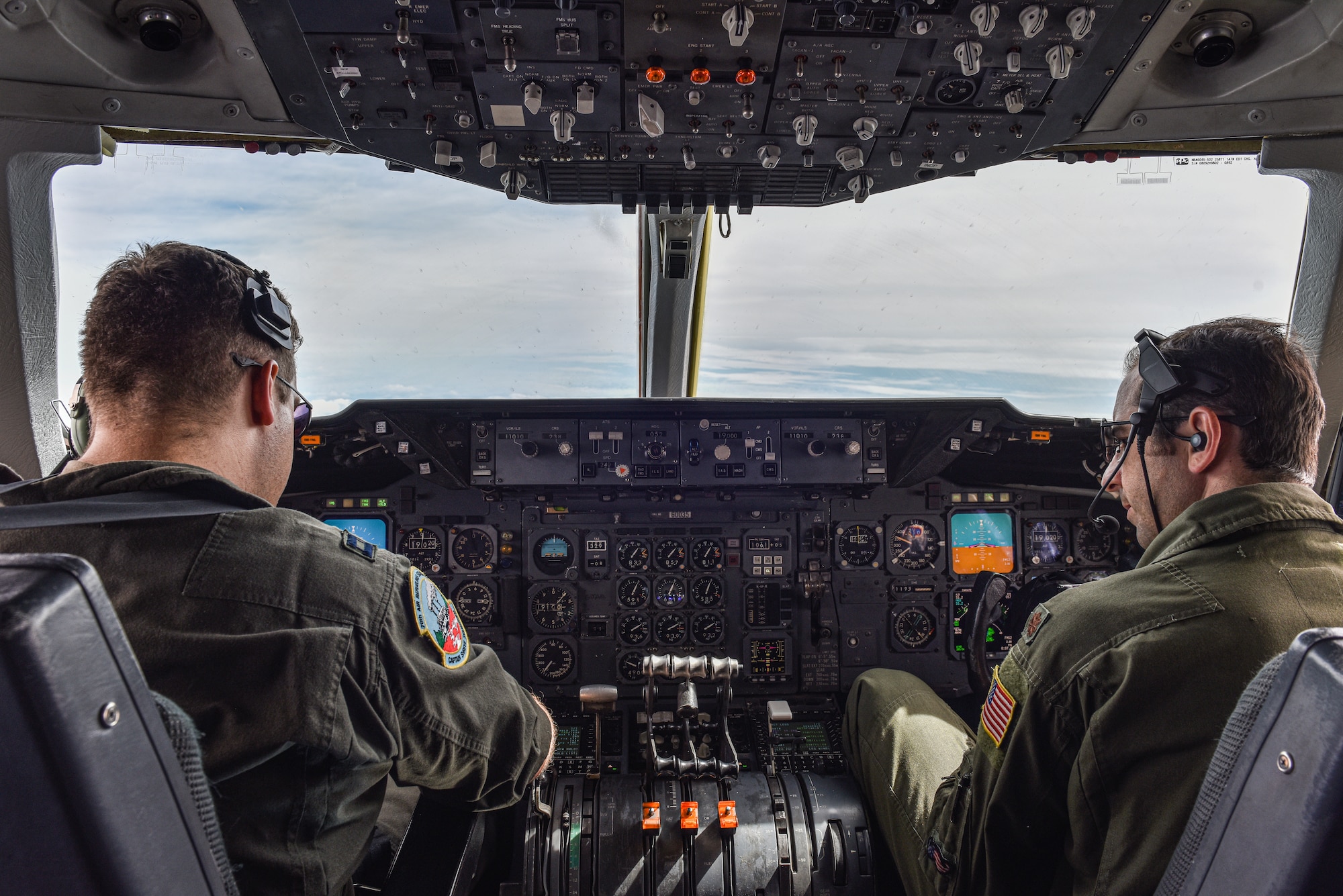 U.S. Air Force Capt. David Crowley, 78th Air Refueling Squadron pilot and 305th Operations Support Squadron Formal Training Unit student, left, and U.S. Air Force Maj. Thomas C. deCiutiis, 305th OSS deputy chief of the Formal Training Unit and instructor pilot, right, coordinate with KC-135 aircrew before in-flight refuel training at Joint Base McGuire-Dix-Lakehurst, N.J., July 8, 2021. The KC-135 Stratotanker aircrew is assigned to the 101st Air Refueling Wing from Bangor Air National Guard Base, Maine. (U.S. Air Force Photo by Staff Sgt. Shay Stuart)