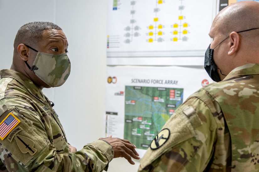 Sgt. Maj. Darnell Cabell, senior enlisted leader and principle advisor to the military deputy to the Assistant Secretary of the Army for Financial Management and Comptroller, talks with Capt. Timothy Bowler, 84th Training Command Diamond Saber exercise planner, during a visit to the exercise at Fort McCoy, Wisconsin, Aug. 17, 2021. Diamond Saber is a U.S. Army Reserve-led exercise that incorporates all Army components and joint services, and it prepares finance and comptroller Soldiers on warfighting functions such as funding the force, payment support, disbursing operations, accounting, fiscal stewardship, auditability and data analytics. (U.S. Army photo by Mark R. W. Orders-Woempner)