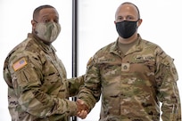 Sgt. Maj. Darnell Cabell, senior enlisted leader and principle advisor to the military deputy to the Assistant Secretary of the Army for Financial Management and Comptroller, presents his challenge coin for excellence to Sgt. 1st Class David Ramirez, 326th Financial Management Support Center internal control manager, during Diamond Saber at Fort McCoy, Wisconsin, Aug. 17, 2021. Diamond Saber is a U.S. Army Reserve-led exercise that incorporates all Army components and joint services, and it prepares finance and comptroller Soldiers on warfighting functions such as funding the force, payment support, disbursing operations, accounting, fiscal stewardship, auditability and data analytics. (U.S. Army photo by Mark R. W. Orders-Woempner)