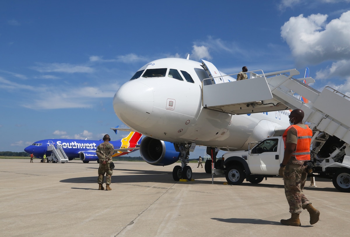 U.S. Soldiers assigned to the 271st Movement Control Team and Airmen from the Kentucky Air National Guard’s 123rd Contingency Response Group receive a plane of Afghan evacuees at Volk Field, Wis., Aug. 29, 2021. The Department of Defense, through U.S. Northern Command, and in support of the Department of State and Department of Homeland Security, is providing transportation, temporary housing, medical screening and general support for up to 50,000 Afghan evacuees at suitable facilities, in permanent or temporary structures, as quickly as possible. This initiative provides Afghan personnel essential support at secure locations outside Afghanistan. (U.S. Army photo by Spc. Eric Cerami/ 55th Signal Company)