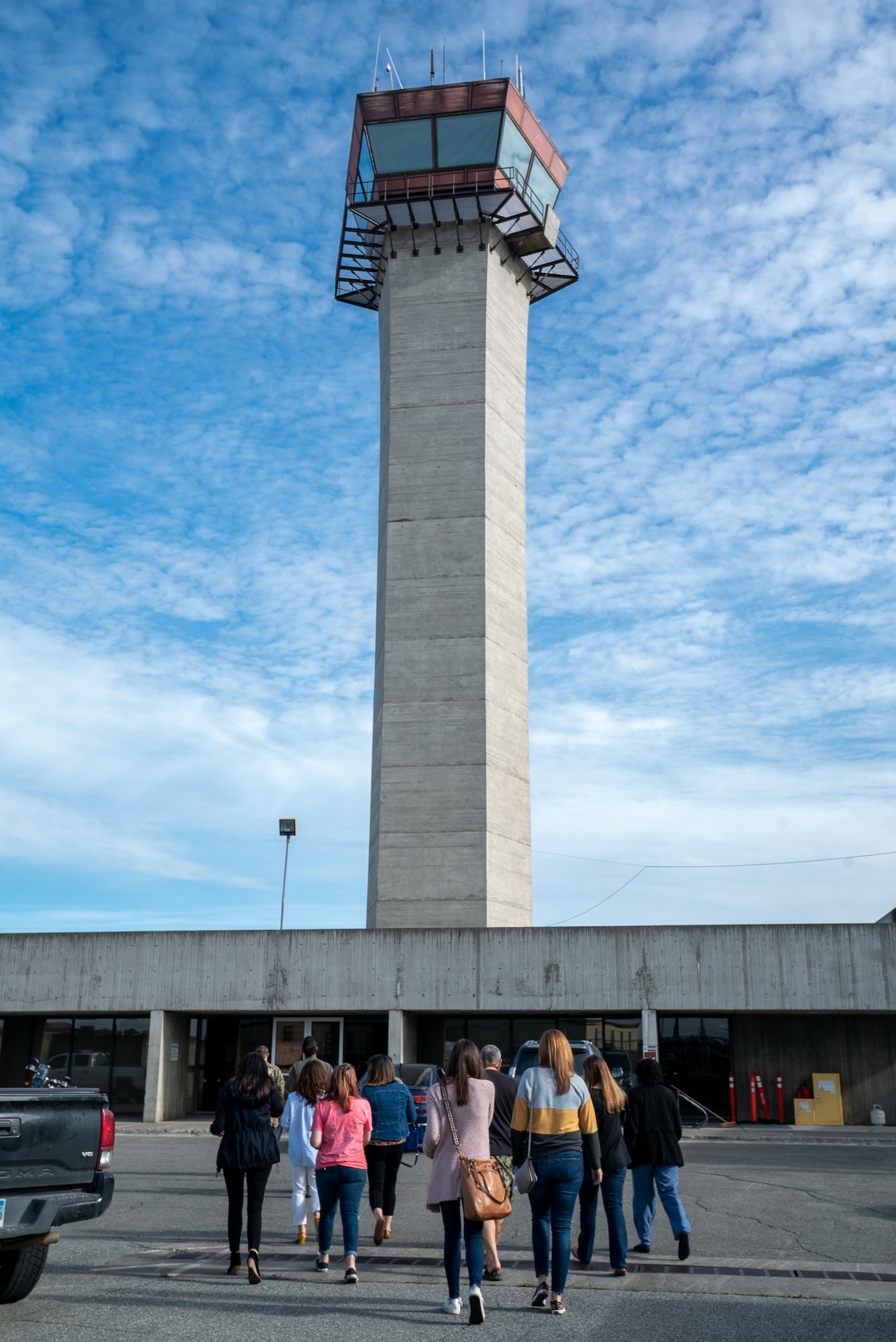 Spouses from the 3rd Wing approach the Air Traffic Control tower during an immersion tour at Joint Base Elmendorf-Richardson, Alaska.