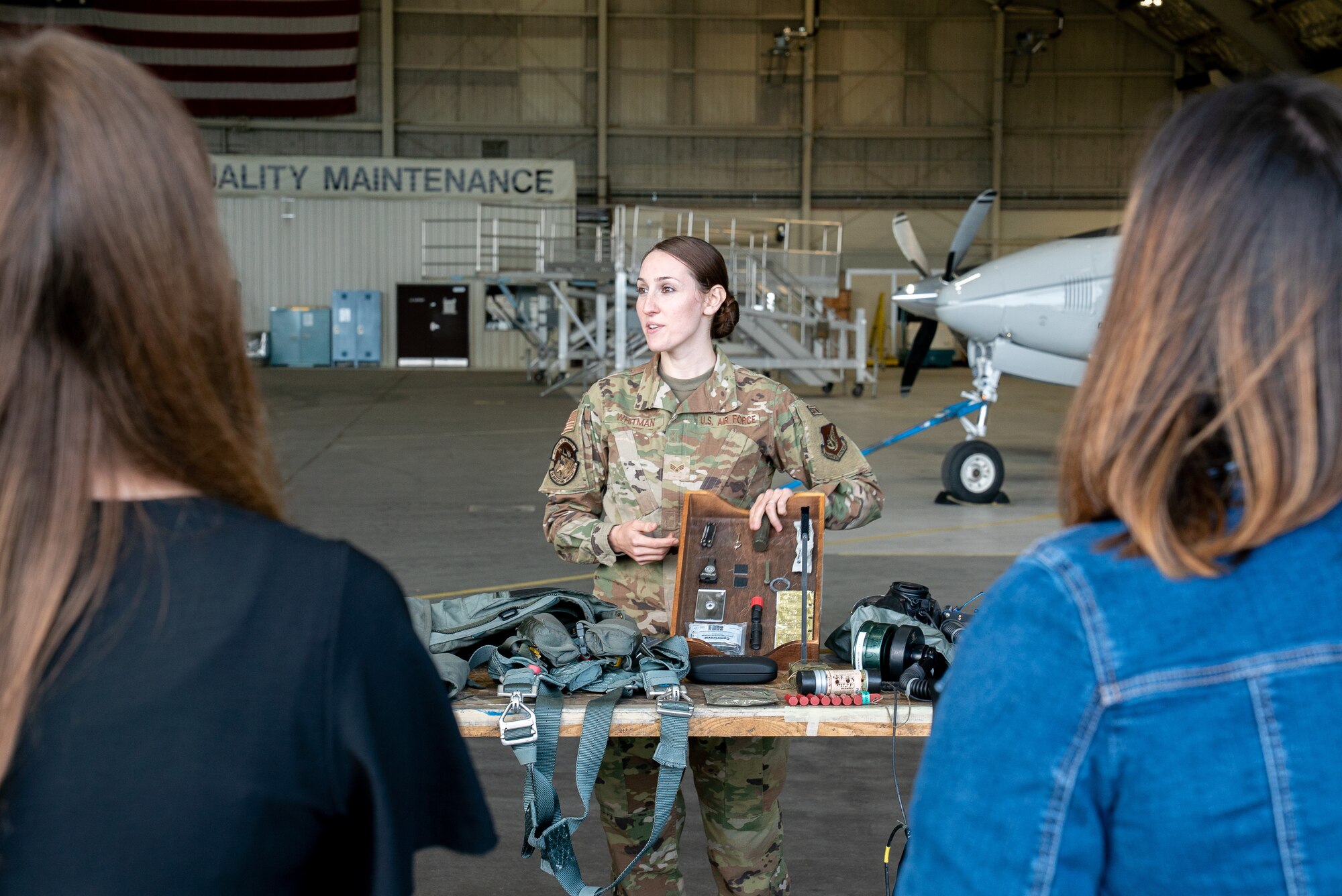 U.S. Air Force Senior Airman Lauren Whitman, a 3rd Operations Support Squadron aircrew flight equipment technician, briefs 3rd Wing spouses during an immersion tour at Joint Base Elmendorf-Richardson, Alaska.