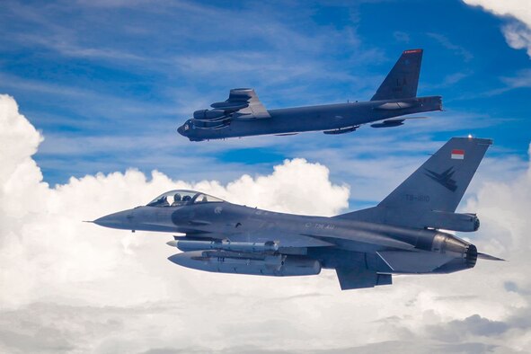 An Indonesian Air Force F-16 flies next to a U.S. Air Force B-52 Stratofortress assigned to the 2nd Bomb Wing, Barksdale Air Force Base, Louisiana, in the Indo-Pacific region, Sept. 1, 2021. This is the first time a B-52 has integrated with the Indonesian Air Force during flight. Bomber Task Force missions demonstrate the credibility of our forces to address a diverse and uncertain security environment.  (Courtesy Photo of Indonesian Air Force)