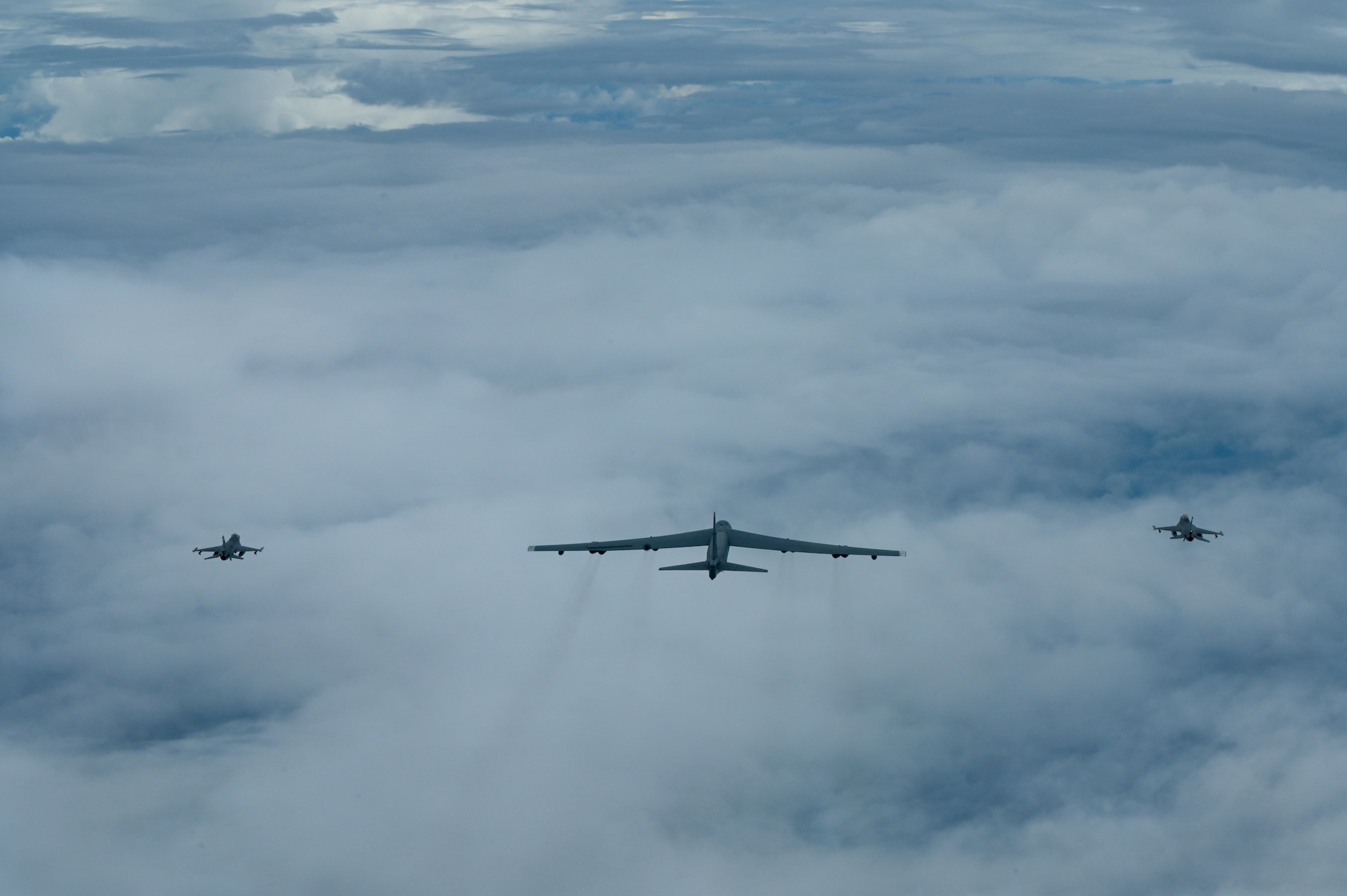 A U.S. Air Force B-52 Stratofortress assigned to the 2nd Bomb Wing, Barksdale Air Force Base, Louisiana, flies next to two Indonesian Air Force F-16s during a Bomber Task Force (BTF) deployment in the Indo-Pacific region, Sept. 1, 2021. This is the first time a B-52 has integrated with the Indonesian Air Force during flight. BTF missions demonstrate the credibility of our forces to address a diverse and uncertain security environment. (U.S. Air Force photo by Tech. Sgt. Matthew Lotz)