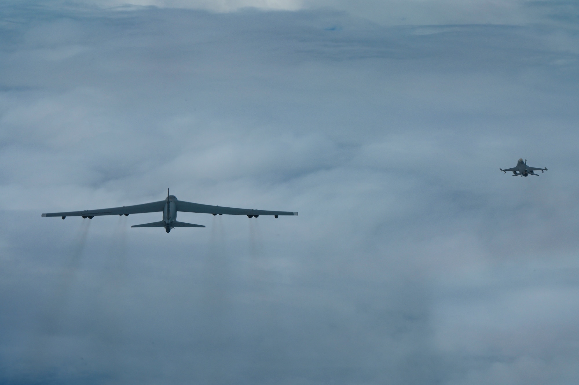 A U.S. Air Force B-52 Stratofortress assigned to the 2nd Bomb Wing, Barksdale Air Force Base, Louisiana, flies next to an Indonesian Air Force F-16 during a Bomber Task Force deployment in the Indo-Pacific region, Sept. 1, 2021. This is the first time a B-52 has integrated with the Indonesian Air Force during flight. The B-52 is a long range bomber with a range of approximately 8,800 miles, enabling rapid support of Bomber Task Force missions or deployments and reinforcing global security and stability. (U.S. Air Force photo by Tech. Sgt. Matthew Lotz)