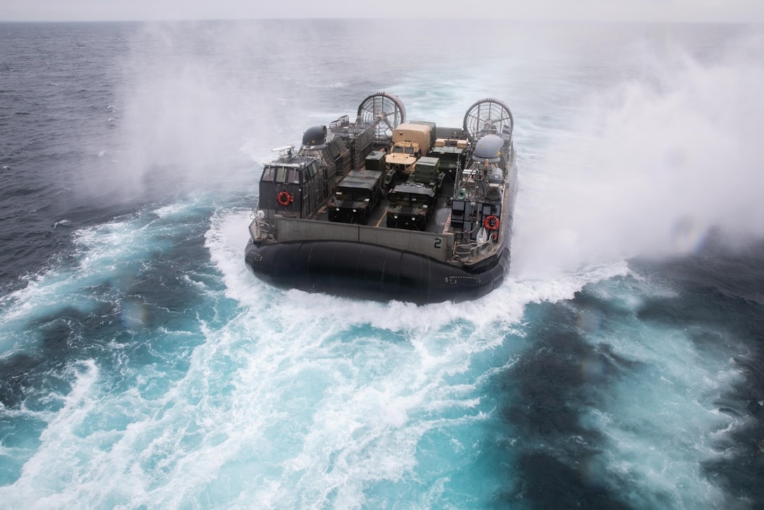 U.S. Marines and Navy sailors conduct landing craft, air cushion operations during Large Scale Exercise 2021 aboard Wasp-Class amphibious assault ship USS Kearsarge USS Kearsarge, August 3, 2021. LSE 2021 demonstrates the Navy’s ability to employ precise, lethal, and overwhelming force globally across three naval component commands, five numbered fleets, and 17 time zones. LSE 2021 merges live and synthetic training capabilities to create an intense, robust training environment. It will connect high-fidelity training and real-world operations, to build knowledge and skills needed in today’s complex, multi-domain, and contested environment.