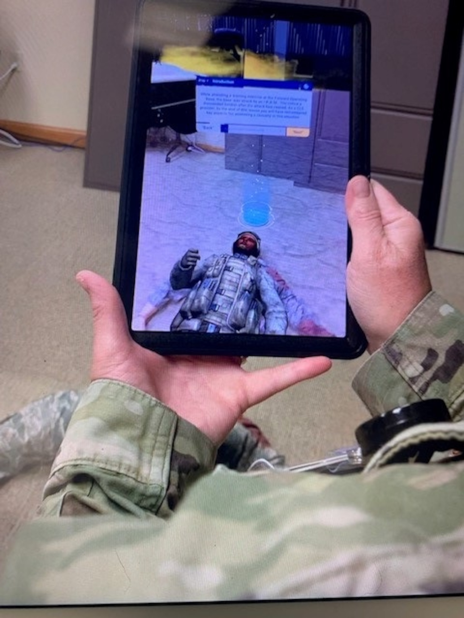 The simulation unit at the 6th Medical Group, MacDill Air Force Base, Florida, looks on as a student moves through the process of emergency care through virtual reality Aug. 3, 2021, in support of the Defense Health Agency’s research and development’s simulation implementation worth $100 million. The introduction of augmented reality training increases the availability of training, without a need to increase manpower availability for training setup and multiple student face-to-face interaction. (Courtesy photo)
