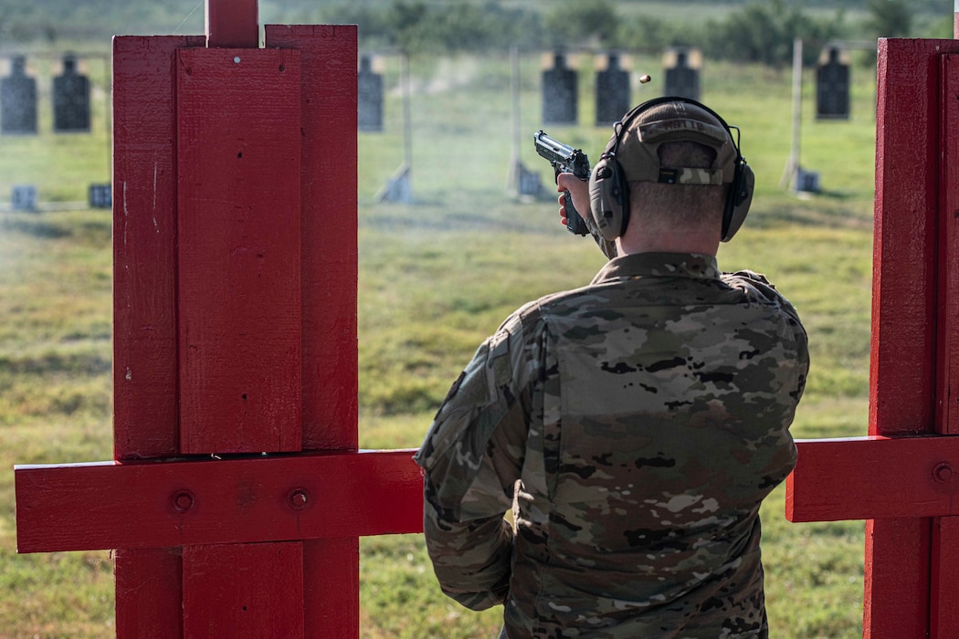 Shooter fires with a Beretta M9