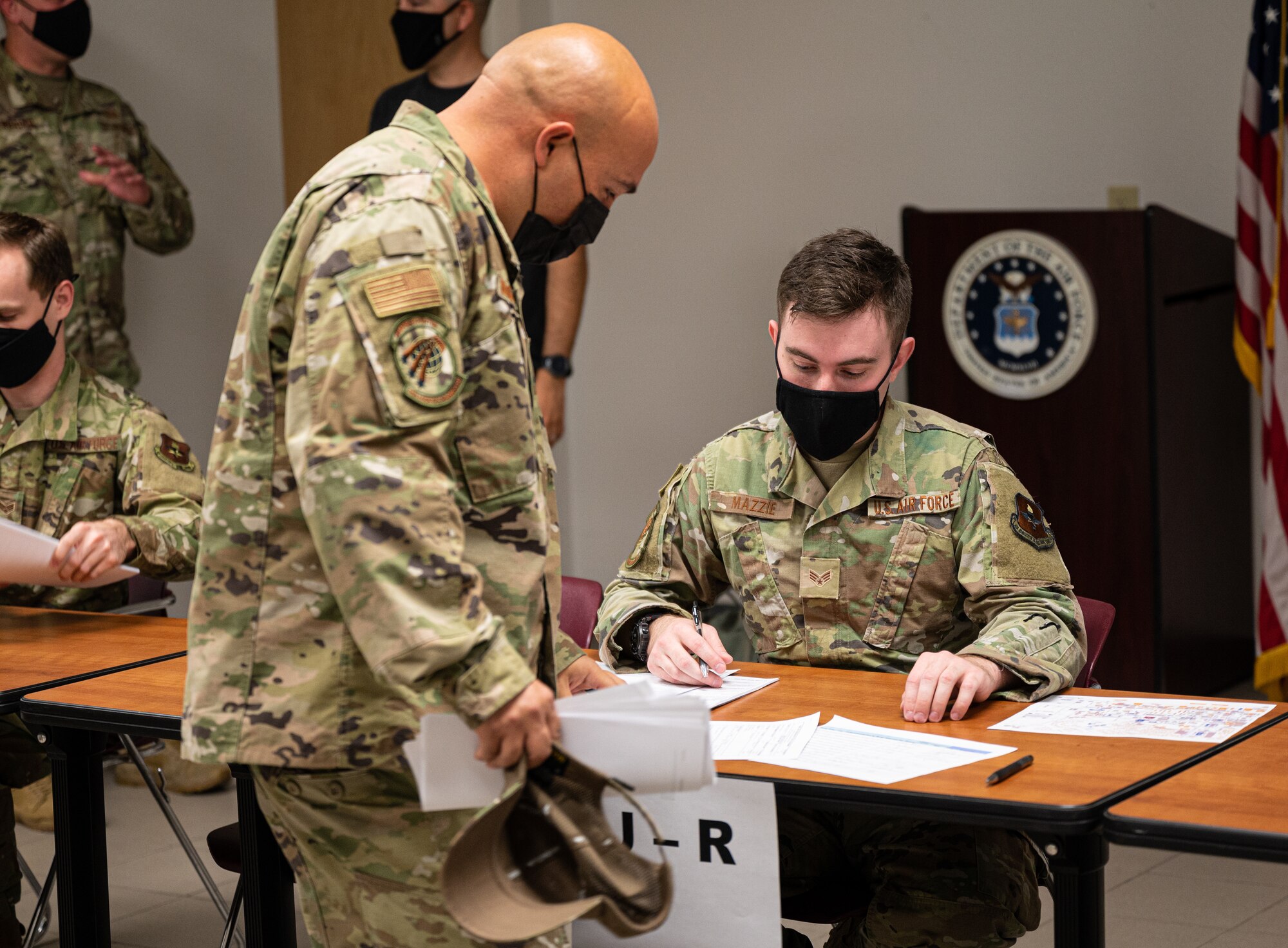 U.S. Air Force Senior Airman Gregory Mazzie, right, 56th Logistics Readiness Squadron logistics planner, assists an Airman assigned to the 56th Fighter Wing with deployment out-processing Aug. 30, 2021, at Luke Air Force Base, Arizona. More than 70 Luke AFB Airmen deployed to Holloman AFB, New Mexico, in support of Operation Allies Welcome. The operation supports the temporary provision of medical screening, lodging, and other general support for Afghan evacuees and their families arriving to several military installations in the United States.  (U.S. Air Force photo by Senior Airman Leala Marquez)