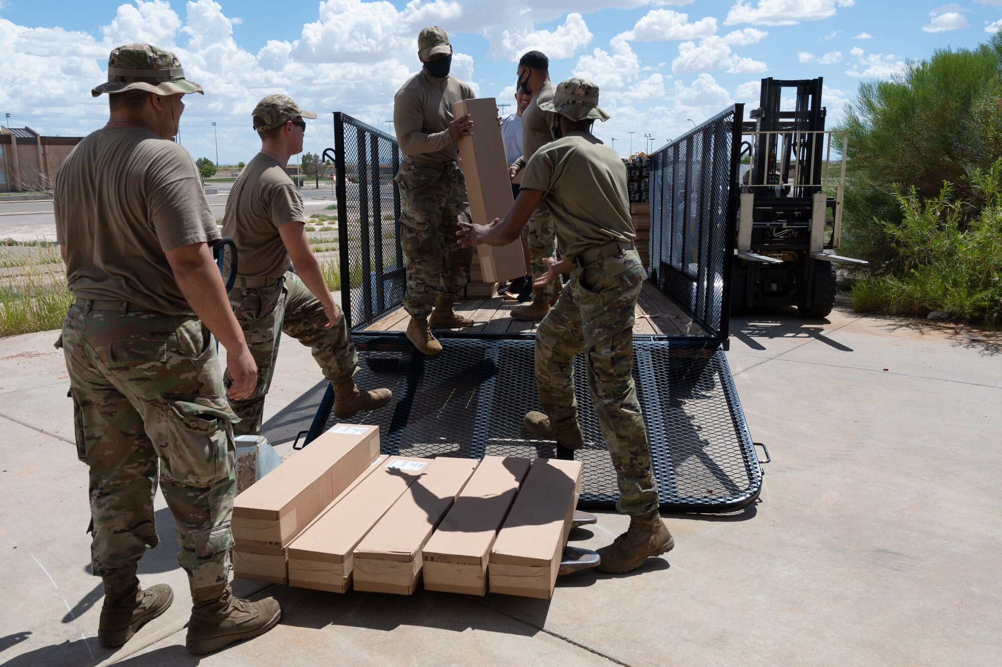 49th Force Support Squadron personnel and volunteers unload cots for Task Force-Holloman personnel Aug. 27, 2021 on Holloman Air Force Base, New Mexico. The Department of Defense, through U.S. Northern Command, and in support of the Department of Homeland Security, is providing transportation, temporary housing, medical screening, and general support for up to 50,000 Afghan evacuees at suitable facilities, in permanent or temporary structures, as quickly as possible. This initiative provides Afghan personnel essential support at secure locations outside Afghanistan. (U.S. Air Force photo by Tech. Sgt. BreeAnn Sachs)