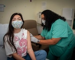 Patrinia Thomas, licensed vocational nurse, administers the COVID-19 vaccination to patient.