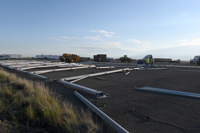 Two civilian contractors prepare structure materials at the future housing facilities construction site in support of Operation Allies Welcome, Aug. 29, 2021, on Holloman Air Force Base, New Mexico. The Department of Defense, through U.S. Northern Command, and in support of the Department of Homeland Security, is providing transportation, temporary housing, medical screening, and general support for up to 50,000 Afghan evacuees at suitable facilities, in permanent or temporary structures, as quickly as possible. This initiative provides Afghan personnel essential support at secure locations outside Afghanistan. (U.S. Air Force photo by Staff Sgt. Christopher S. Sparks)