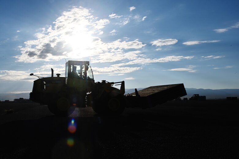 A civilian contractor transports flooring material with a forklift at the future Afghan personnel housing facilities construction site in support of Operation Allies Welcome, Aug. 29, 2021, on Holloman Air Force Base, New Mexico. The Department of Defense, through U.S. Northern Command, and in support of the Department of Homeland Security, is providing transportation, temporary housing, medical screening, and general support for up to 50,000 Afghan evacuees at suitable facilities, in permanent or temporary structures, as quickly as possible. This initiative provides Afghan personnel essential support at secure locations outside Afghanistan. (U.S. Air Force photo by Staff Sgt. Christopher S. Sparks)