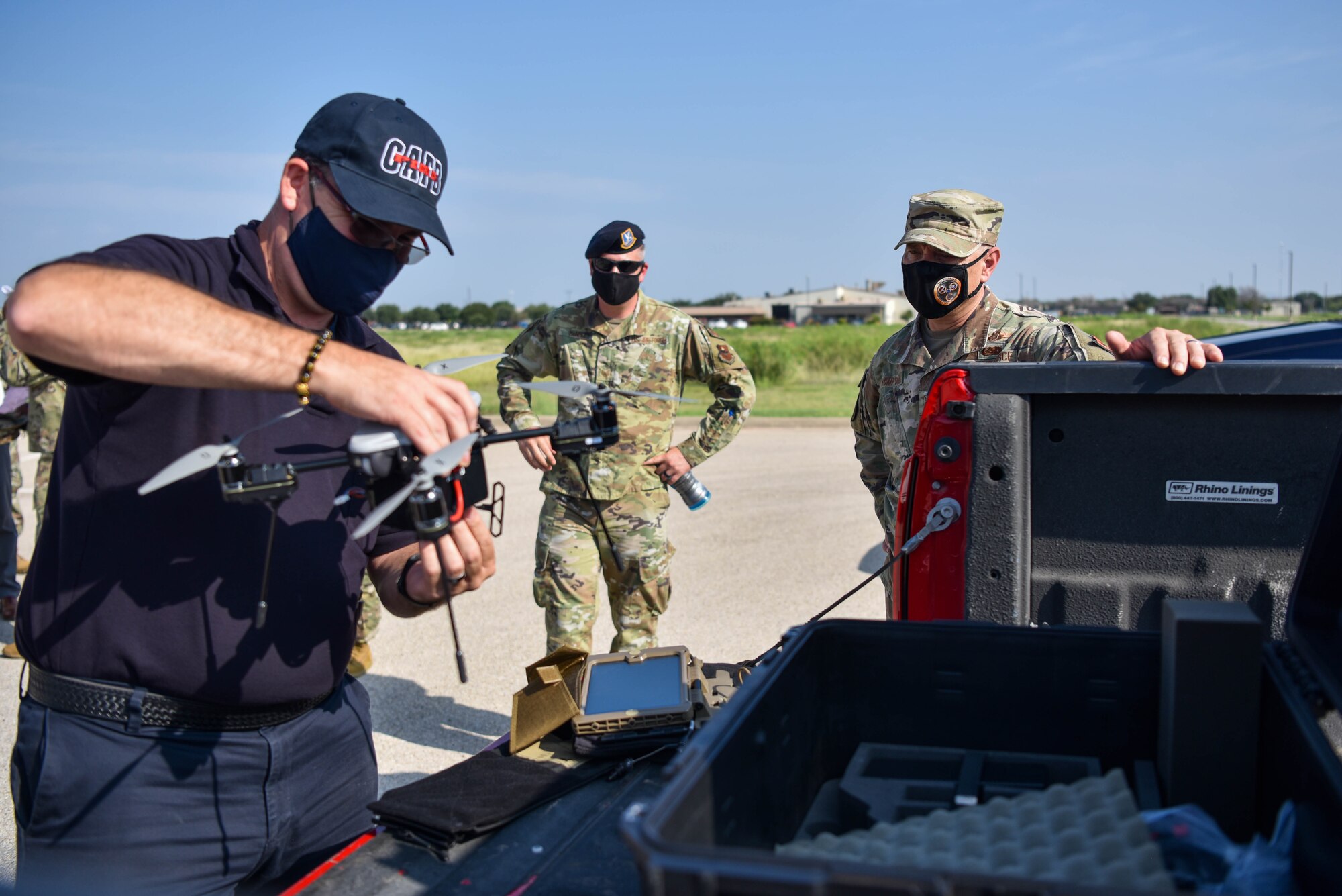 AETC command chief observes a demonstration of a drone.