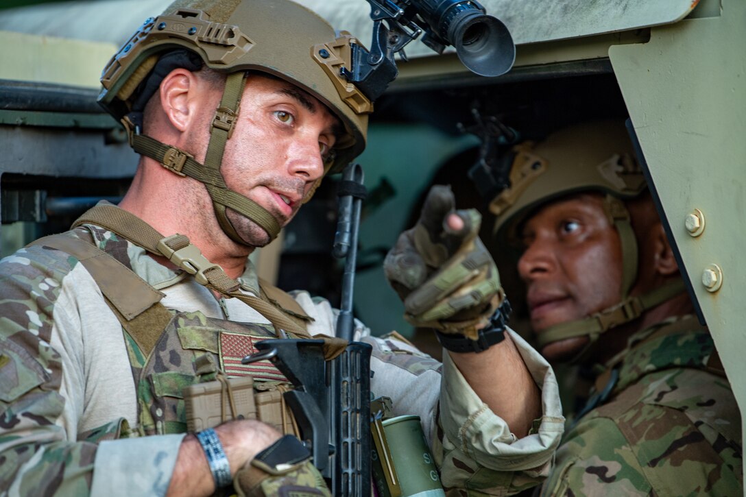 Photo of two Airmen talking
