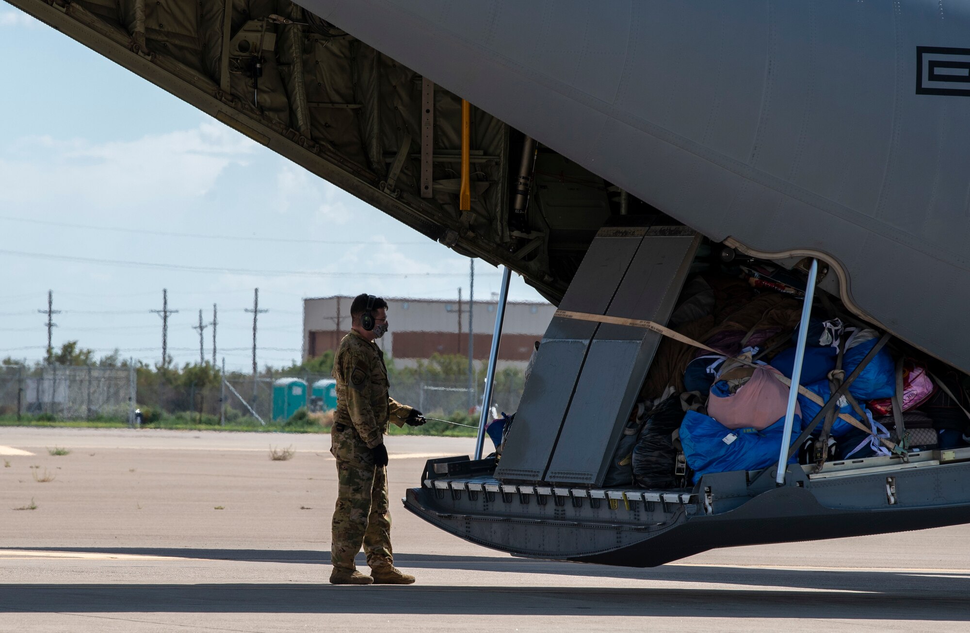 An Airman assigned to Task Force - Holloman prepares to unload luggage in support of Operation Allies Welcome, Aug. 31, 2021, on Holloman Air Force Base, New Mexico. The Department of Defense, through U.S. Northern Command, and in support of the Department of Homeland Security, is providing transportation, temporary housing, medical screening, and general support for up to 50,000 Afghan evacuees at suitable facilities, in permanent or temporary structures, as quickly as possible. This initiative provides Afghan personnel essential support at secure locations outside Afghanistan. (U.S. Air Force photo by Airman 1st Class Jessica Sanchez-Chen)
