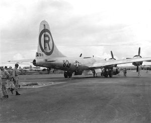 Maintenance and munitions crews back up the Enola Gay over a pit to upload the atomic bomb at Tinian's North Field, 1945. (U.S. Army Air Forces file photo)