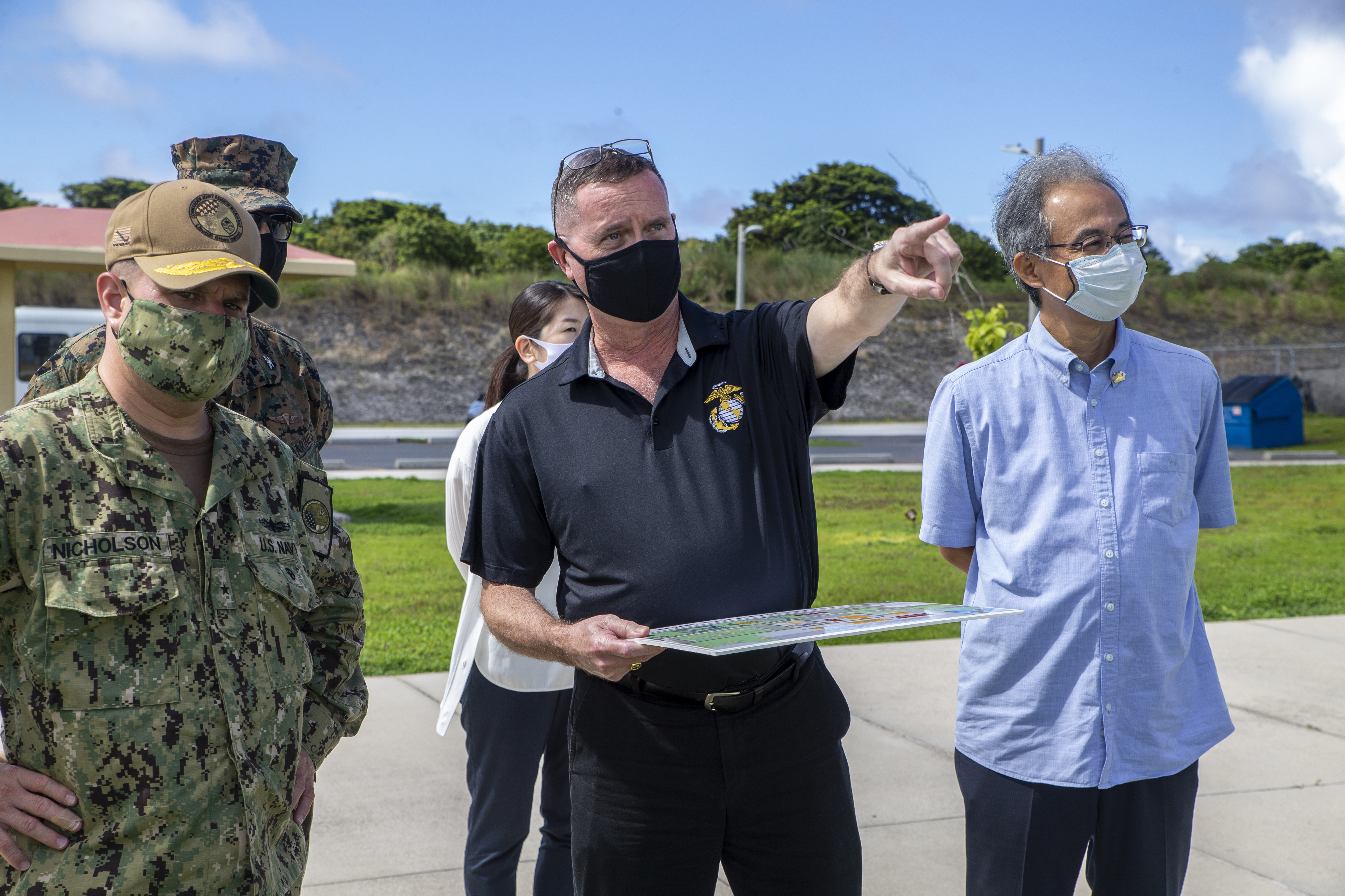 Donald Baldwin, the Marine Corps Base (MCB) Camp Blaz Chief of Staff, center, briefs Rear Adm. Benjamin Nicholson, the Joint Region Marianas Commander, and Kobayashi Toshiaki, the Consul General of Japan in Hagåtña, during a visit to the base, Sept. 2, 2021.