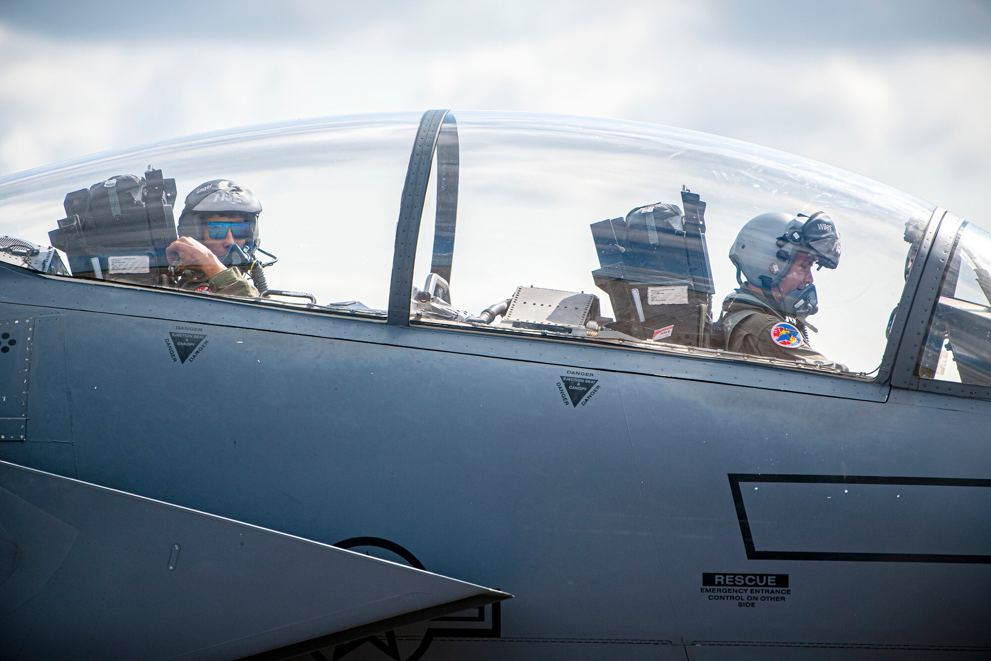 U.S. Air Force 1st Lt. Kyle Gager, left, 492d Fighter Squadron weapons systems officer, and 1st Lt. Zach Wiles, 492d FS pilot, sit in the cockpit of an F-15E Strike Eagle during an Agile Combat Employment exercise at RAF Fairford, England, Aug. 23, 2021. The exercise enables U.S. forces in Europe to operate from locations with varying levels of capacity and support. This further ensures Airmen and aircrews are postured to deliver lethal combat power across the full spectrum of military operations. (U.S. Air Force photo by Senior Airman Eugene Oliver)