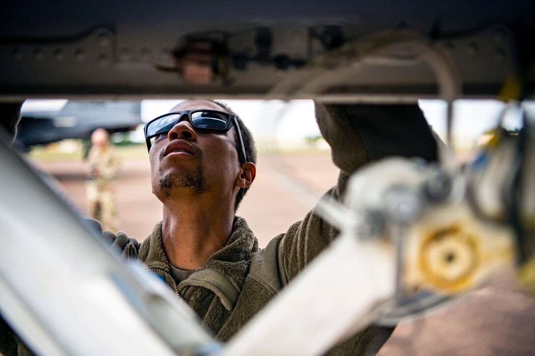 Airman 1st Class Kevaughn Kerr, 48th Aircraft Maintenance Squadron crew chief, inspects an F-15E Strike Eagle assigned to the 492d Fighter Squadron during an Agile Combat Employment exercise at RAF Fairford, England, Aug. 23, 2021.Utilizing ACE concepts ensures that U.S. forces in Europe are better equipped to operate from locations with varying levels of capacity and support to accomplish the mission. This further ensures Airmen and aircrews are postured to deliver lethal combat power across the full spectrum of military operations. (U.S. Air Force photo by Senior Airman Eugene Oliver)