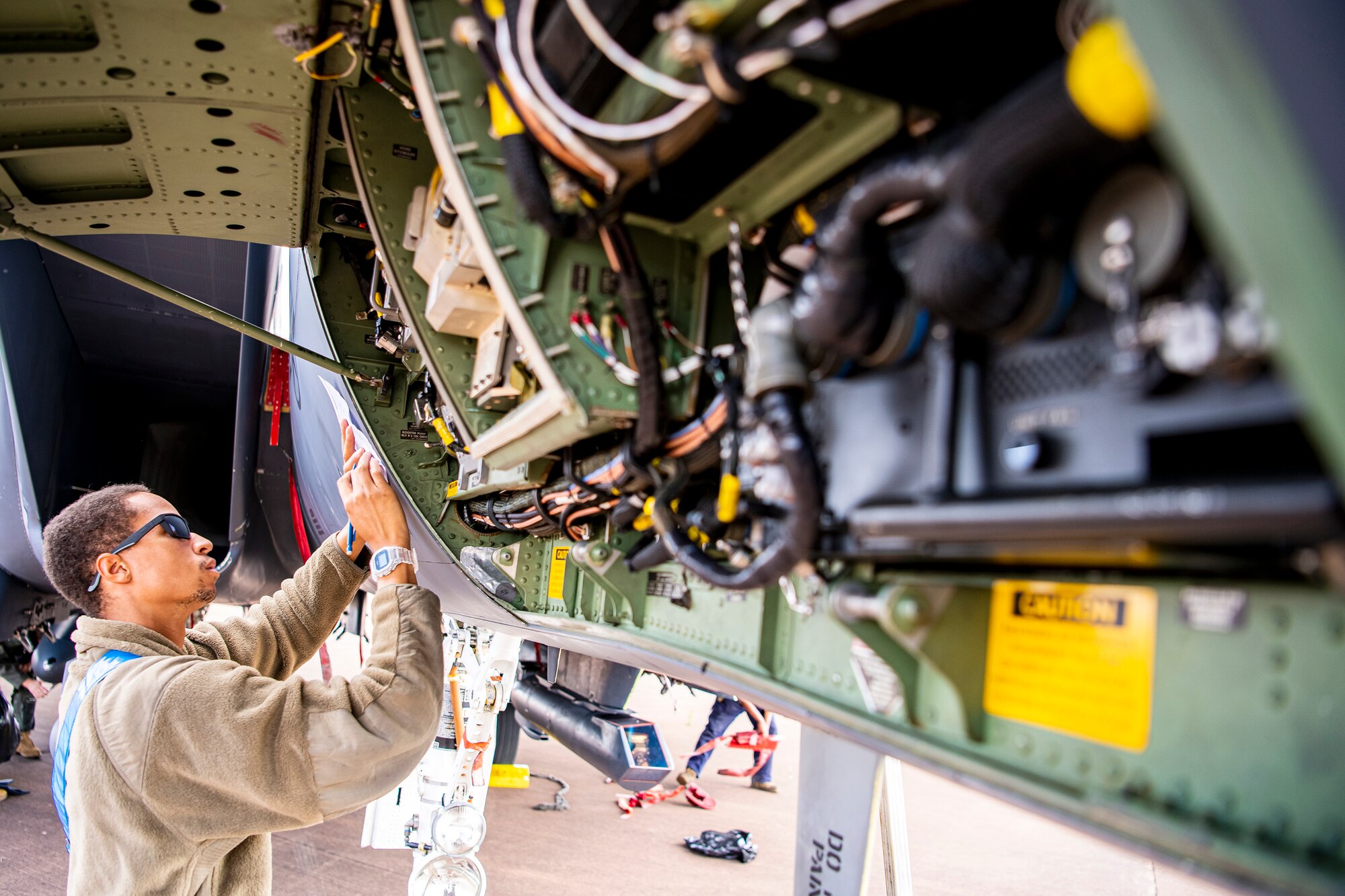 Airman 1st Class Kevaughn Kerr, 48th Aircraft Maintenance Squadron crew chief, writes down notes during an Agile Combat Employment exercise at RAF Fairford, England, Aug. 23, 2021. The exercise enables U.S. forces in Europe to operate from locations with varying levels of capacity and support. This further ensures Airmen and aircrews are postured to deliver lethal combat power across the full spectrum of military operations. (U.S. Air Force photo by Senior Airman Eugene Oliver)