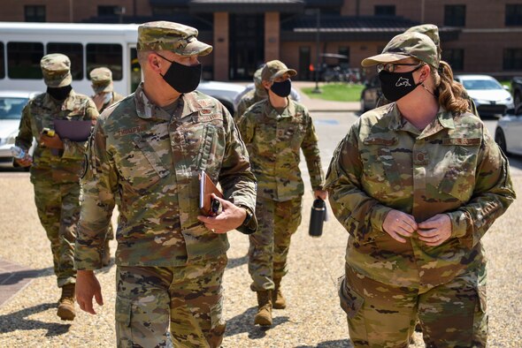 AETC command chief enters building.