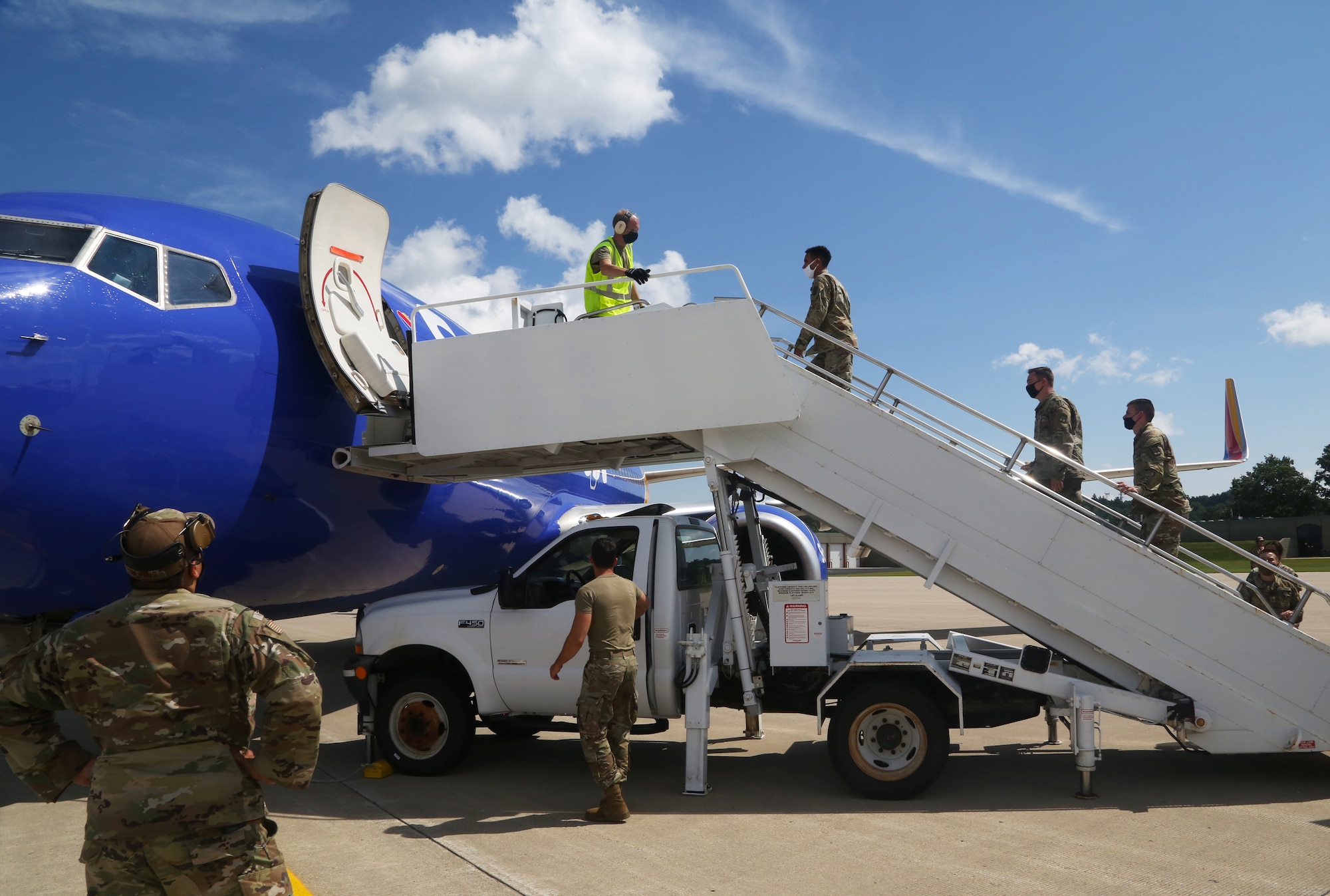 U.S. Soldiers assigned to the 271st Movement Control Team and Airmen from the Kentucky Air National Guard’s 123rd Contingency Response Group receive a plane of Afghan evacuees at Volk Field, Wis., Aug. 29, 2021. The Department of Defense, through U.S. Northern Command, and in support of the Department of State and Department of Homeland Security, is providing transportation, temporary housing, medical screening and general support for up to 50,000 Afghan evacuees at suitable facilities, in permanent or temporary structures, as quickly as possible. This initiative provides Afghan personnel essential support at secure locations outside Afghanistan. (U.S. Army photo by Spc. Eric Cerami/ 55th Signal Company)