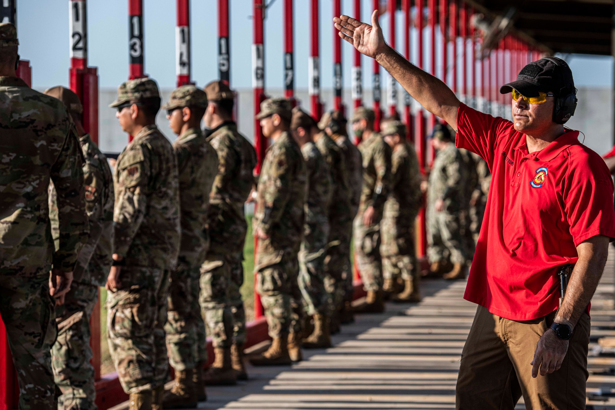 Instructor in red shirt signals during competition