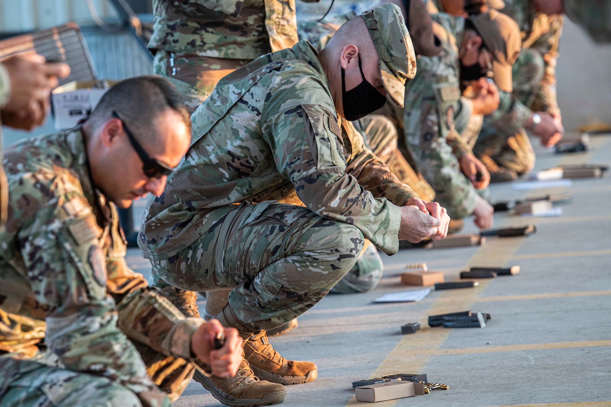 Uniformed members load clips at range