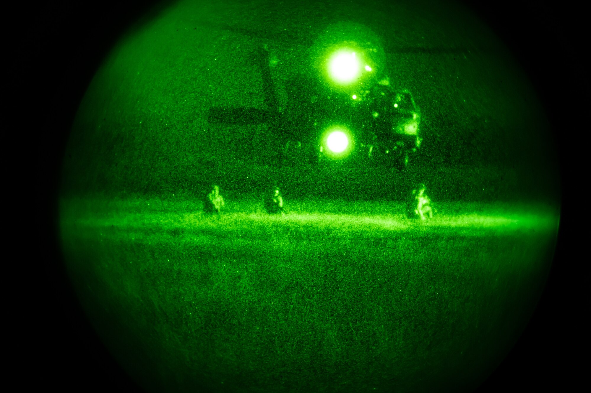 Photo of Airmen in front of a helicopter