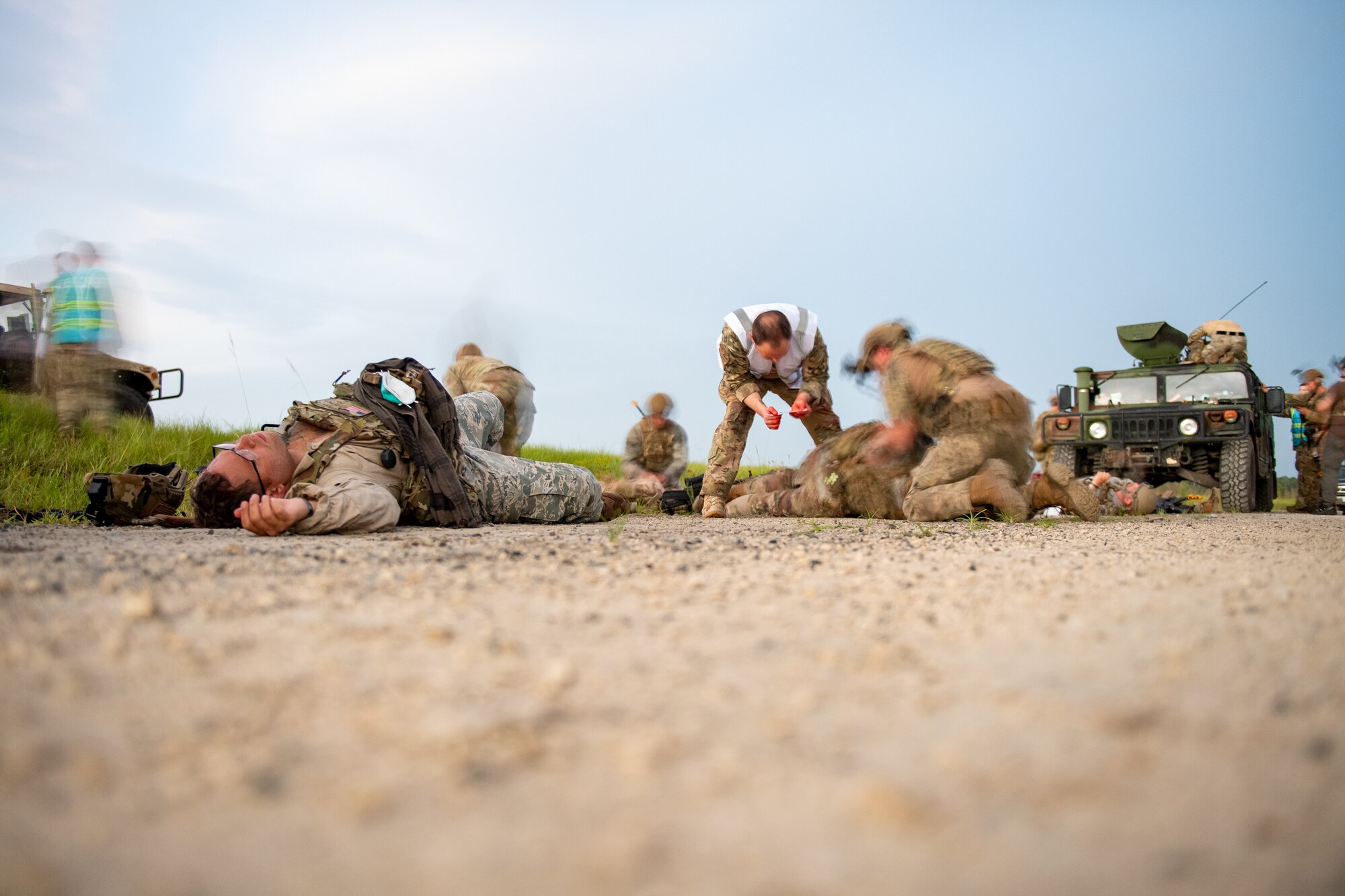 Photo of Airmen conducting medical training on a dirt road