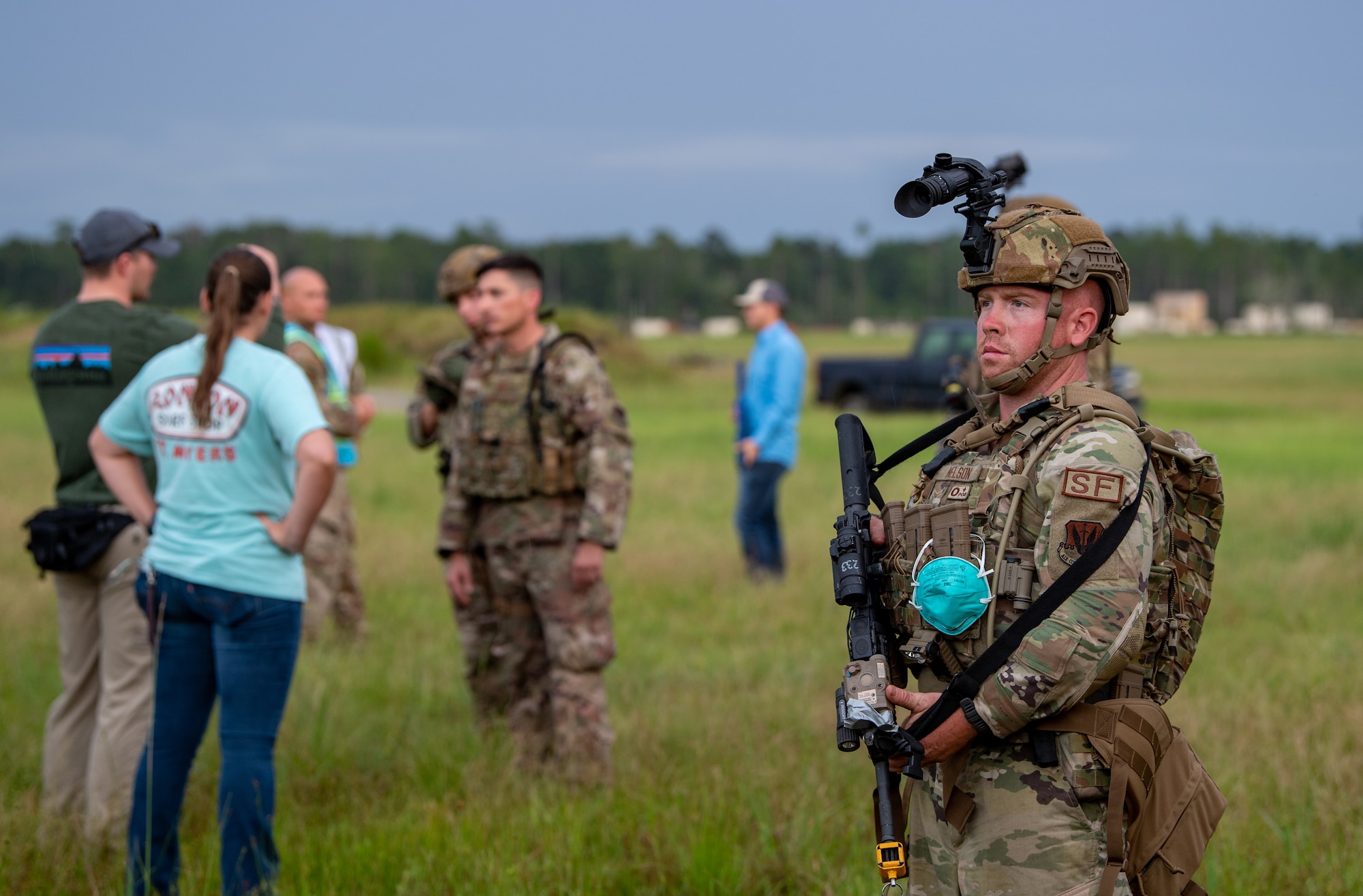 Photo of Airmen standing in a field