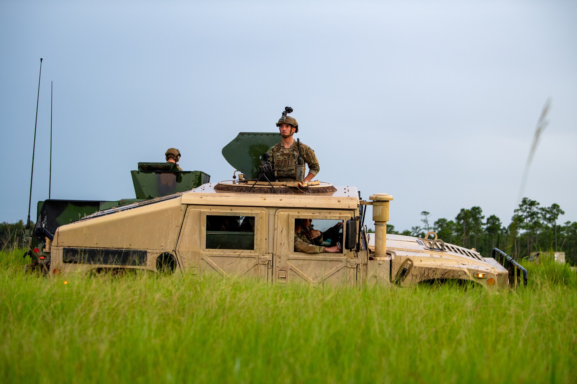 Photo of Airmen operating a Humvee