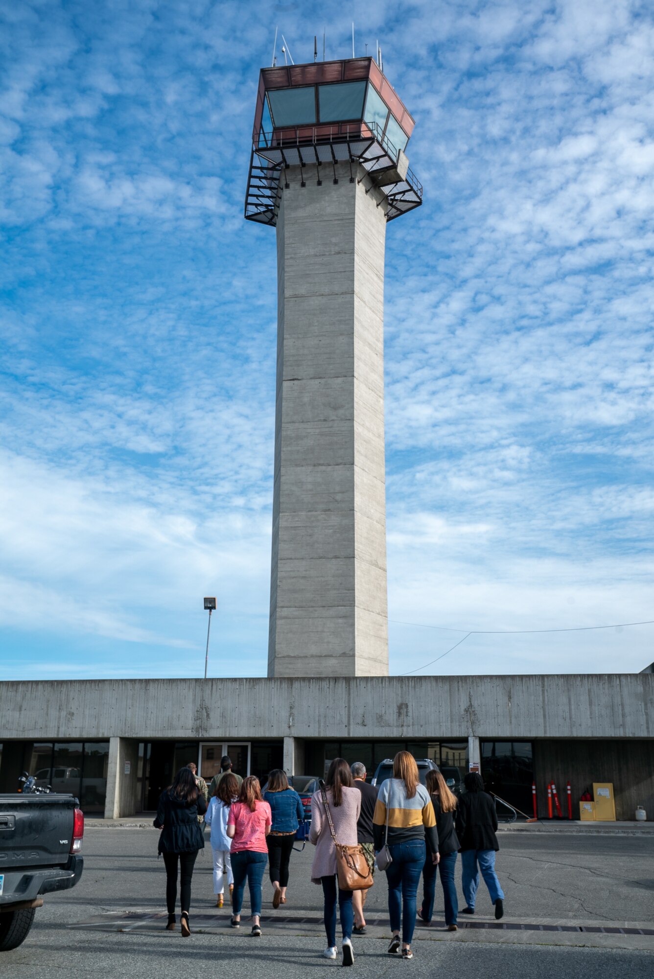 Spouses from the 3rd Wing approach the Air Traffic Control tower during an immersion tour at Joint Base Elmendorf-Richardson, Alaska.