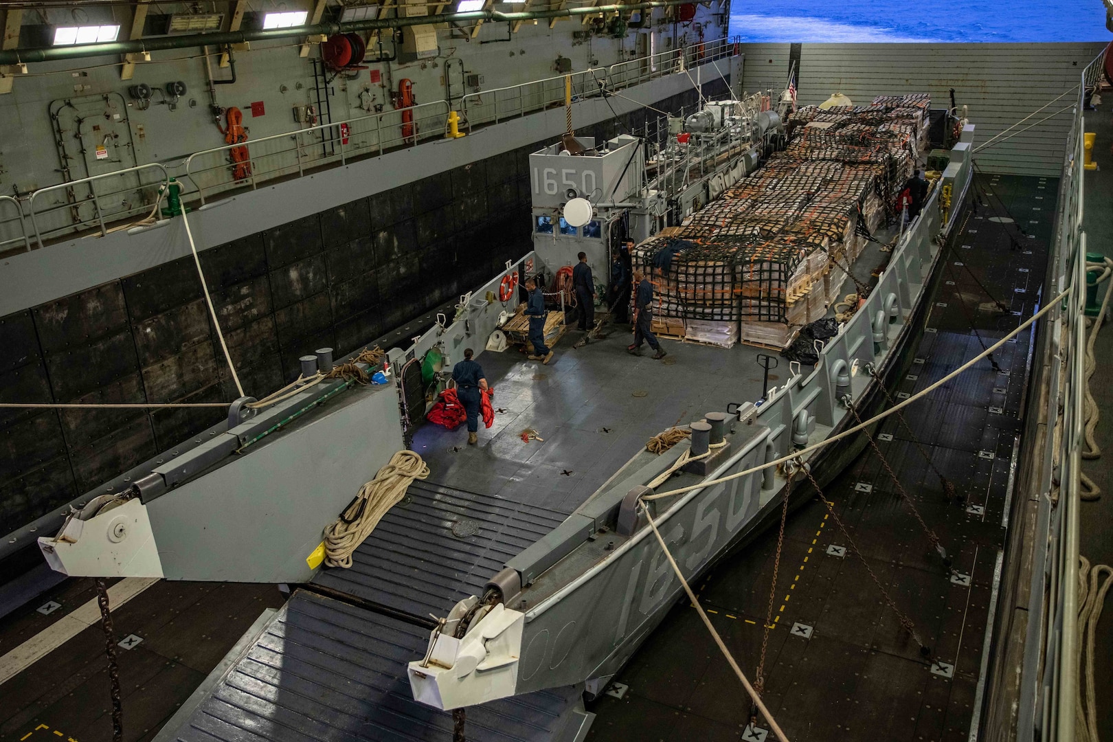 Sailors prepare to launch a landing craft, utility (LCU), assigned to Assault Craft Unit (ACU) 2, from the well deck of USS Arlington (LPD 24) to deliver humanitarian aid to the Port of Jeremie, Haiti, Aug. 31.