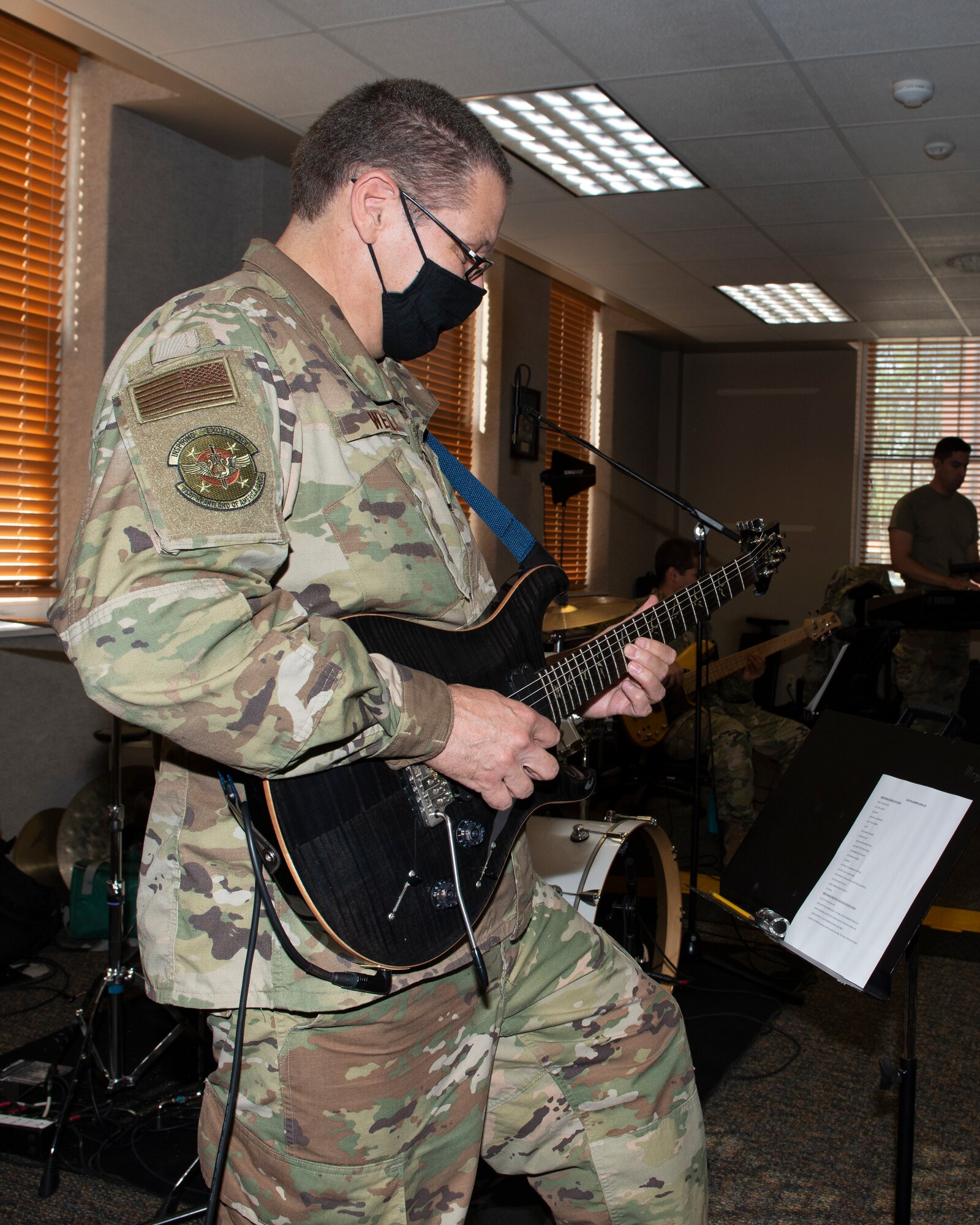 airman in uniform playing his guitar