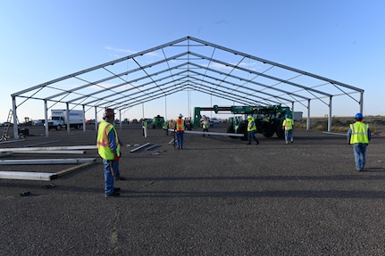 Civilian contractors prepare framework material for a future Afghan personnel housing facility in support of Operation Allies Welcome, Aug. 29, 2021, on Holloman Air Force Base, New Mexico. The Department of Defense, through U.S. Northern Command, and in support of the Department of Homeland Security, is providing transportation, temporary housing, medical screening, and general support for up to 50,000 Afghan evacuees at suitable facilities, in permanent or temporary structures, as quickly as possible. This initiative provides Afghan personnel essential support at secure locations outside Afghanistan. (U.S. Air Force photo by Staff Sgt. Christopher S. Sparks)